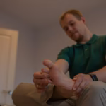 Person massaging the ball of foot pain for relief.