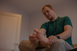 Person massaging the ball of foot pain for relief.